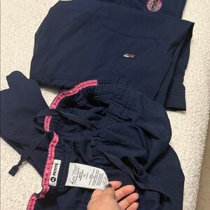 Navy blue scrub pants with pink accents